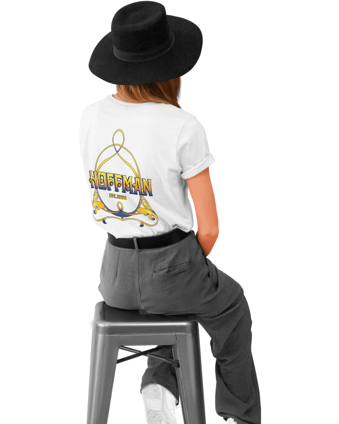 Woman in graphic tee and hat seated
