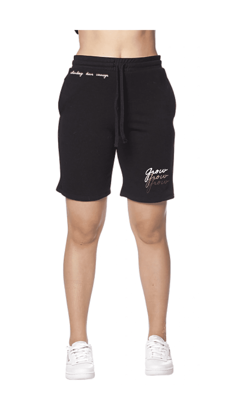Woman wearing black shorts and sneakers